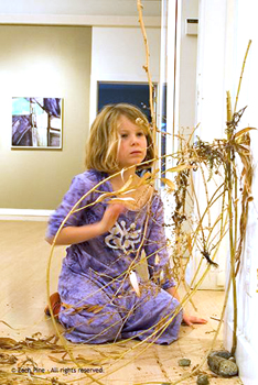 Child working on nature sculpture at art gallery